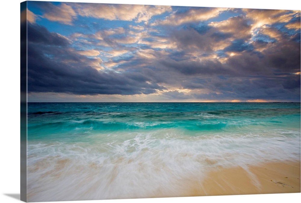 A giant photograph of a beach on the Ambergris Cay Island within the Turks and Caicos Islands.  The colorful ocean contras...