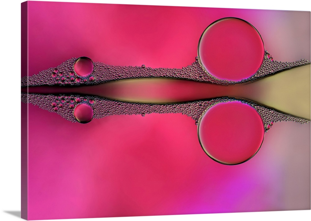Reflecting drops of water on a pink, purple, and yellow background, resembling a scissor shape.
