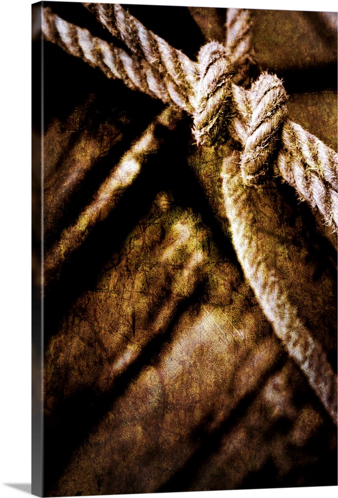 This fine art photograph of a knot tied and out of focus wood planks in the background. This photograph has had several ar...
