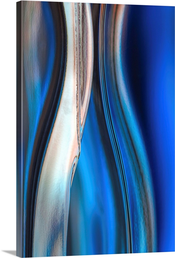 Contemporary abstract photograph of curved linear lines in shades of blue.