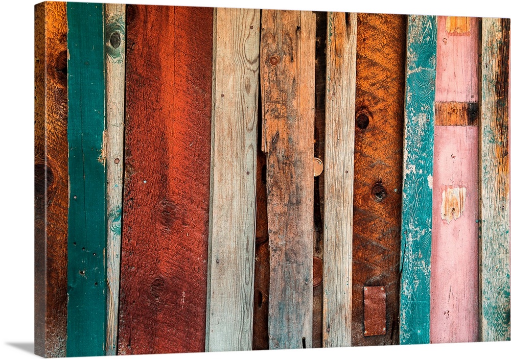 Various painted wooden panels of an old wall.