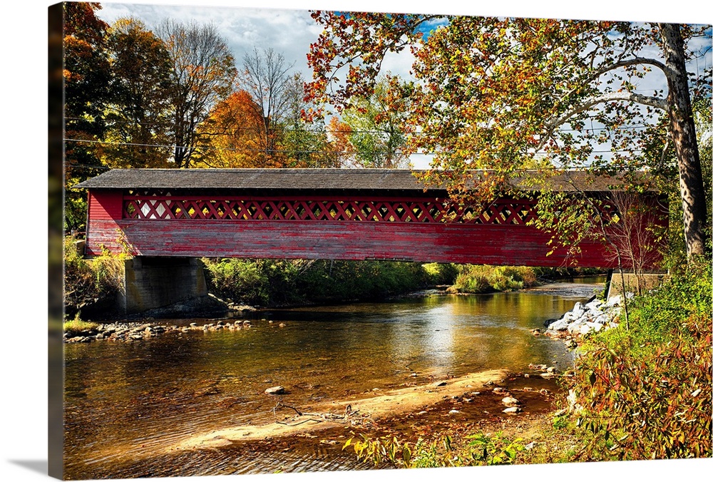 Fine art photo of a historic covered bridge over the Waloomsac River in New England.
