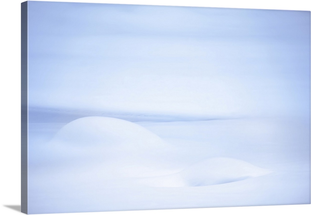 Closeup of snow close to a lake, minimalist Winter image in light blue and white.