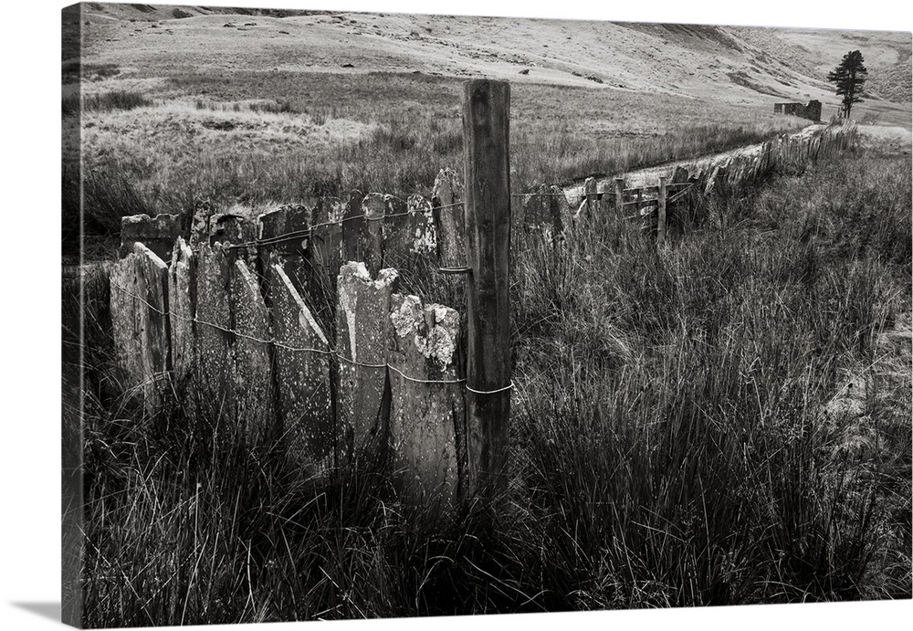 A black and white photograph of a countryside landscape.