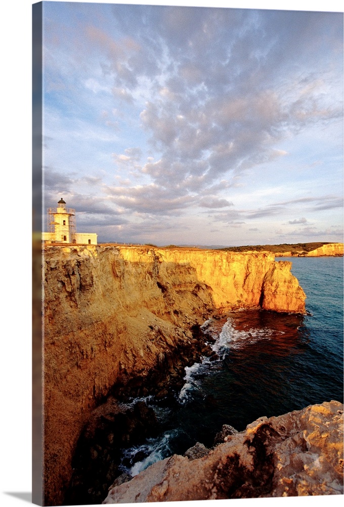 Photo on canvas of a lighthouse on top of a cliff overlooking the ocean.
