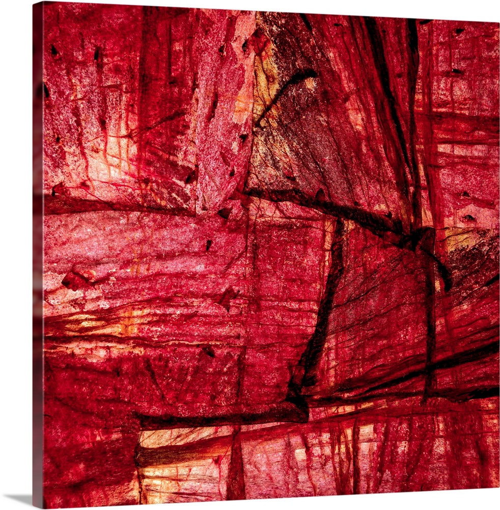 Square abstract art with sections of wood placed together in shades of red and orange.