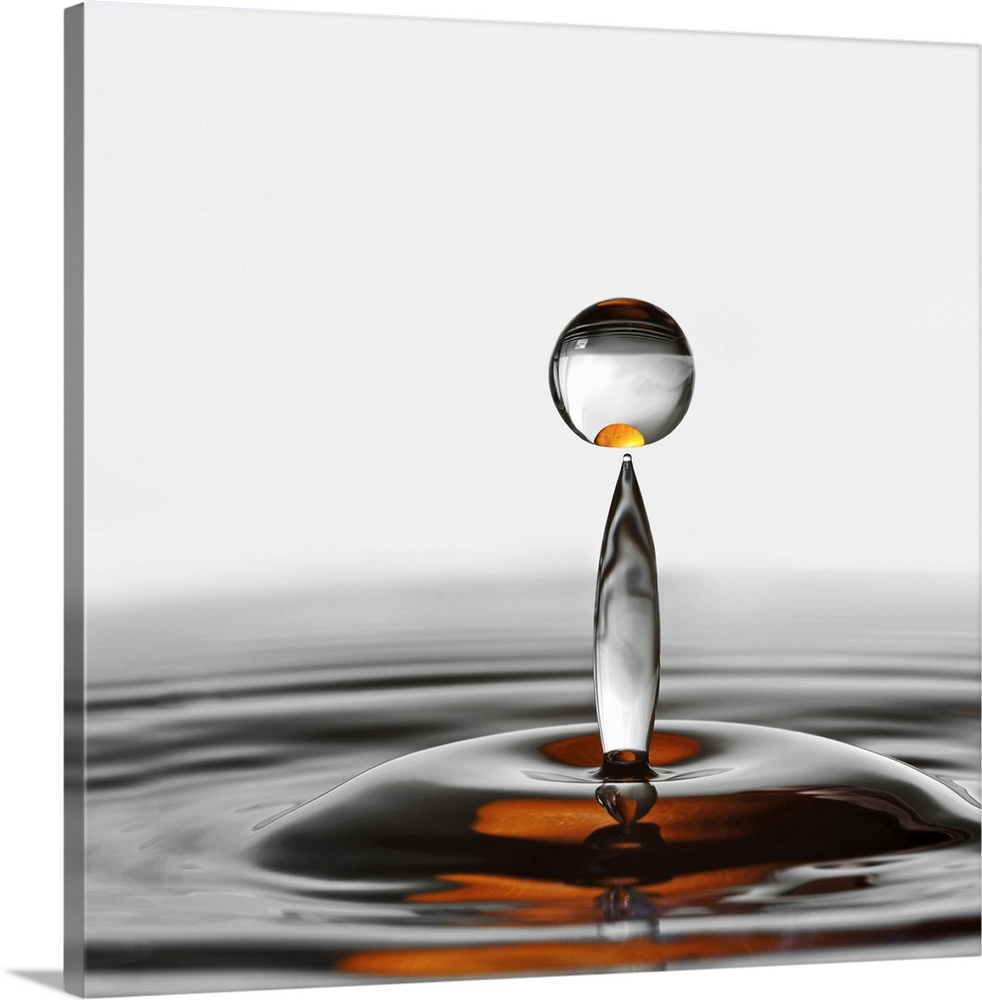 A photograph of a water droplet rising up from a splash.