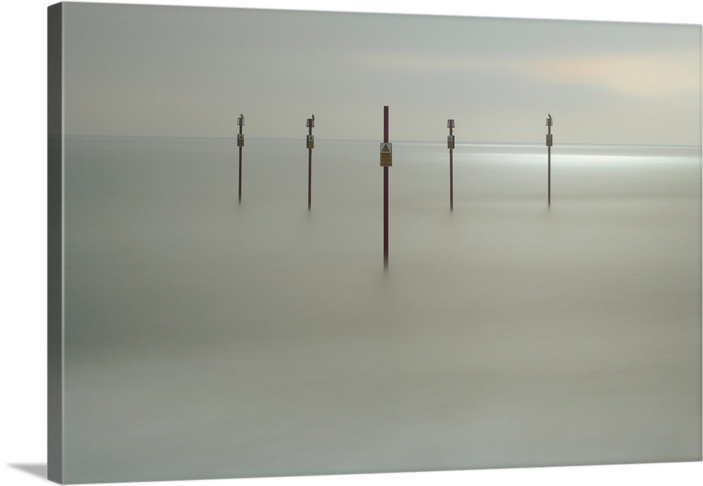 Fine art photograph of sign posts in a clam sea shore.