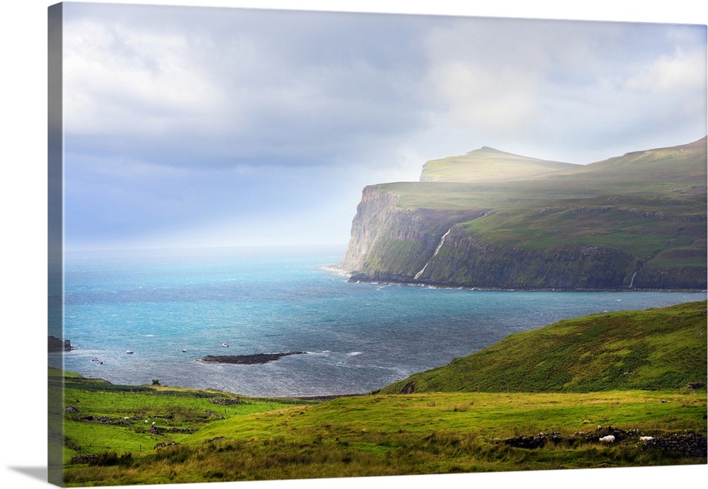 Fine art photo of cliffs at the edge of the sea under bright sunlight.
