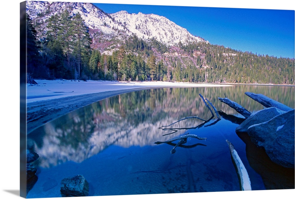 Landscape, big photograph of the still waters of Emerald Bay at Lake Tahoe, California, surrounded by a snow covered lands...