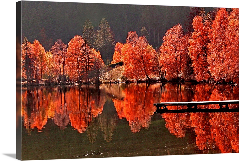 Large photograph includes a brightly covered tree line as it sits on the edge of a lake with a dock and reflects over the ...