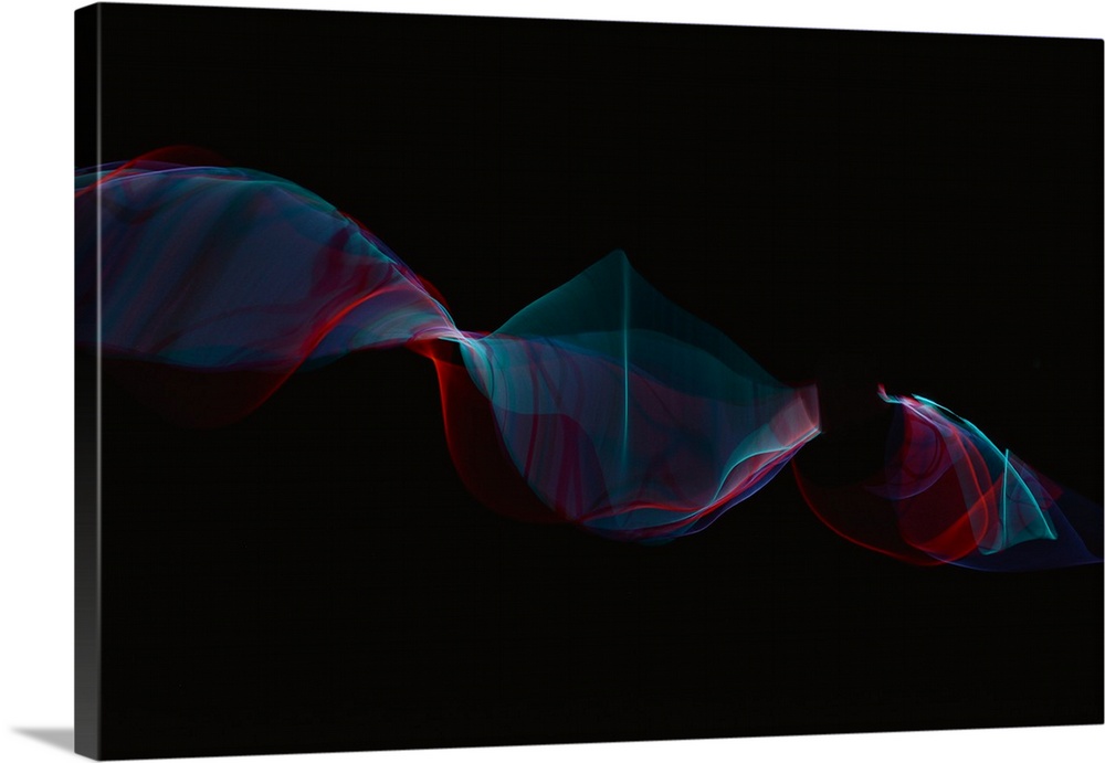 Abstract image created by trailing blue and red lights, resembling wisps of smoke.