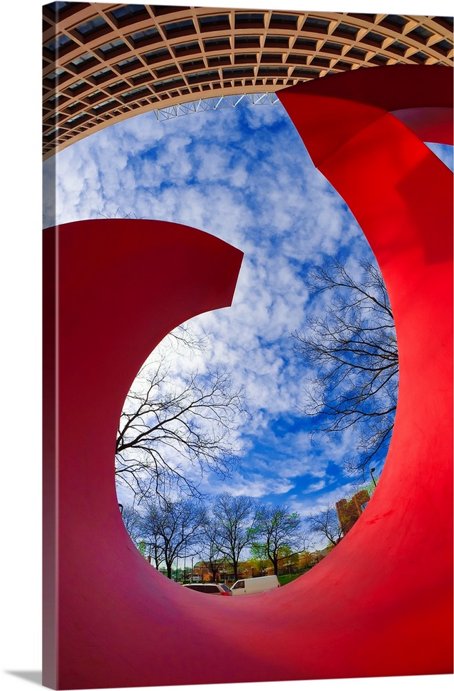 Abstract view of a red sculpture in contrast against the blue sky.