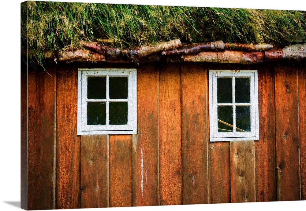 Two little windows in a wooden wall with a grassy roof.