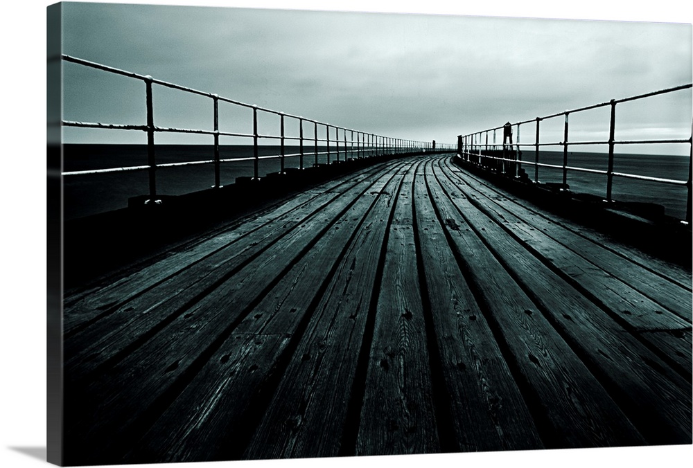 Docor for the home or office of a photograph that has been taken staring down a pier that comes to a vanishing point in th...