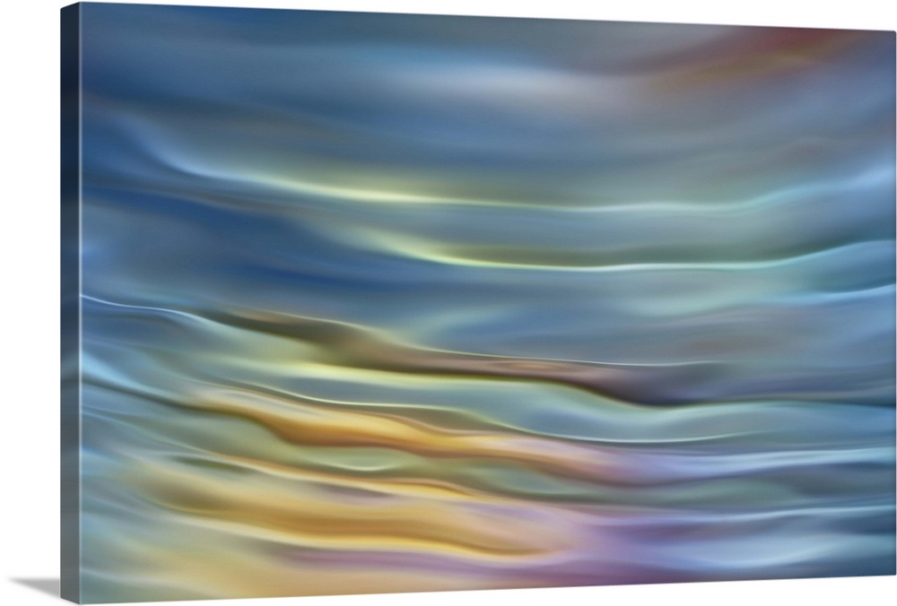 Abstract photograph in pastel yellow and blue shades resembling ocean waves.