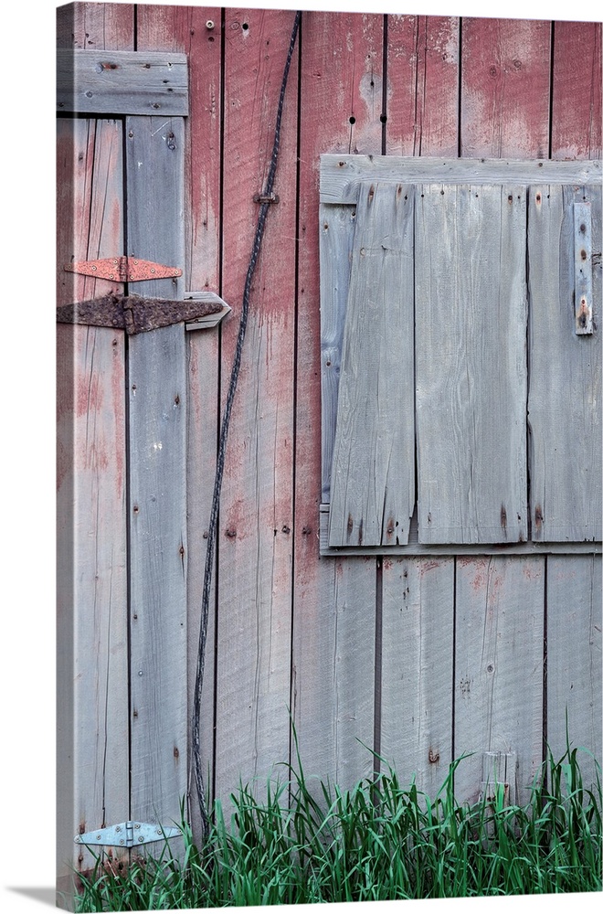 Closeup of the side of a weathered barn with fading colors.