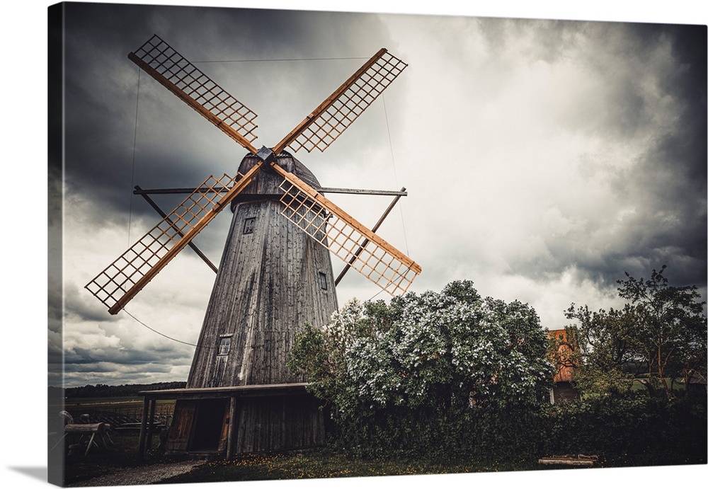 Old windmill in front of a stormy sky