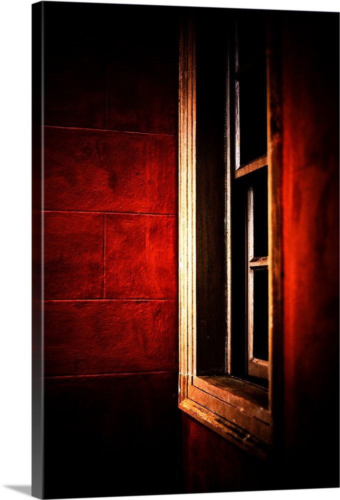 A white framed window set at an angle in walls of deep glowing crimson red.