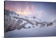 image thumbnail of Colored sunset landscape scene on a snowy mountain in the Alpes in France. A pine valley in winter during a quiet moment.