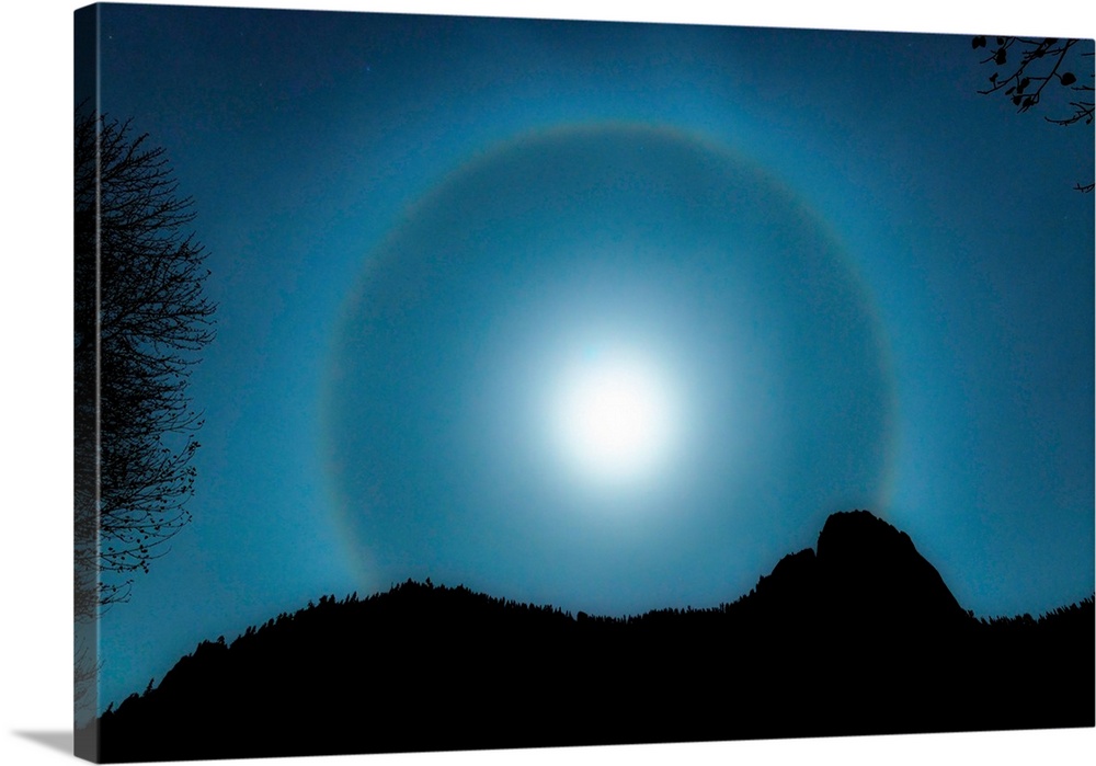 A halo light effect around the full moon in the sky over Yosemite National Park.