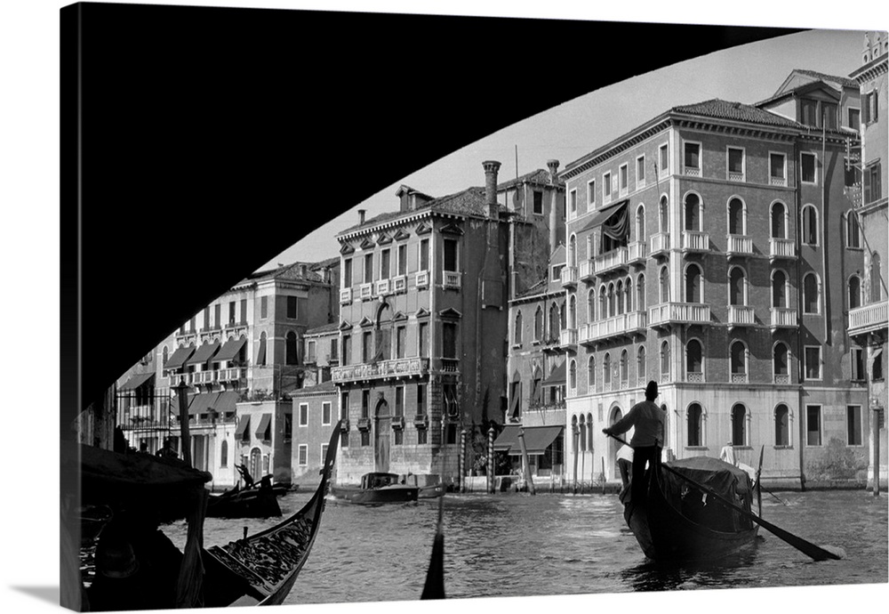 1920's 1930's Gondola Beneath Rialto Bridge Grand Canal Venice Italy.