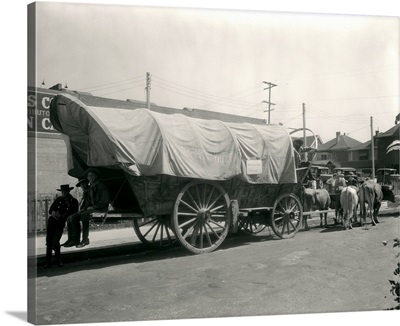 1920's Ox Drawn Conestoga Covered Wagon Parked Along Street