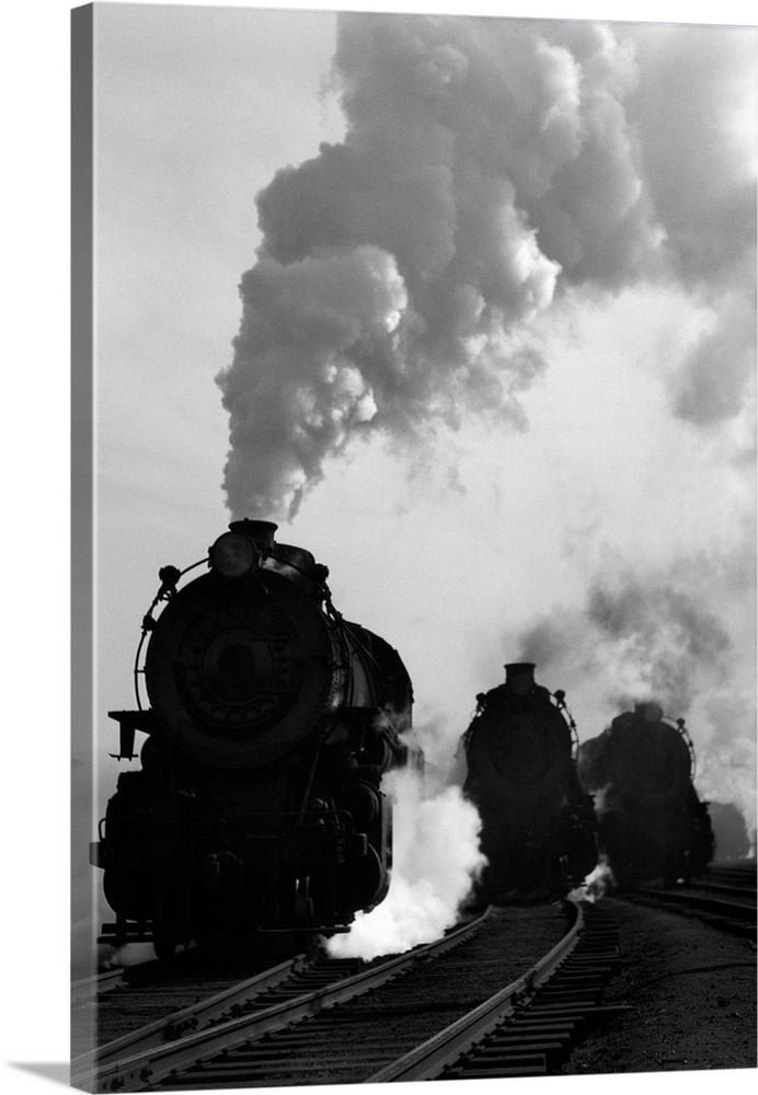 1930's 1940's Head-On View Of Three Steam Engines Silhouetted Against Billowing Smoke And Steam Outdoor.