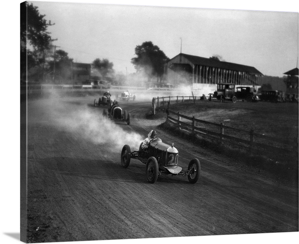 1930's Auto Race On Dirt Track With Cars Going Around Turn Kicking Up Dust.