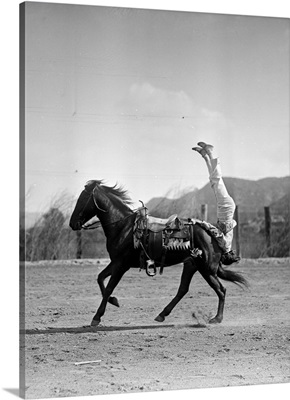 1930s Equestrian Trick Rider Performing Stunt Hanging Upside Down Of Galloping Horse