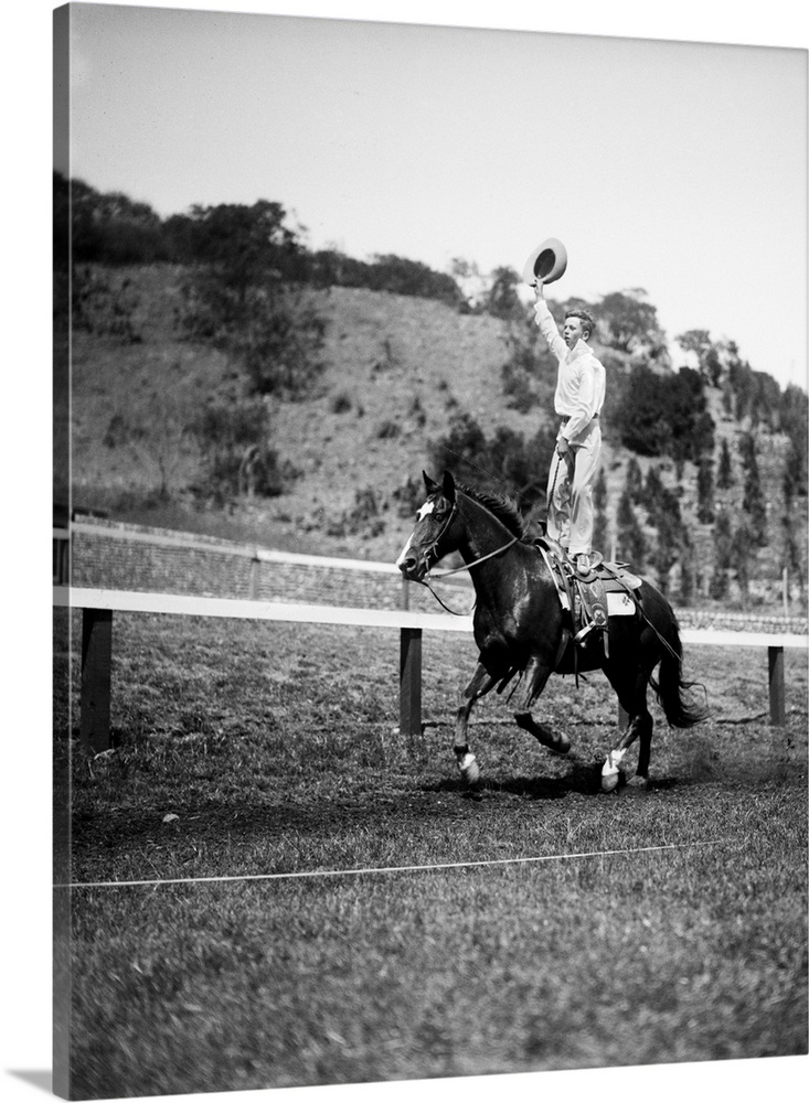 1930s Jim Rogers Son Of Actor Will Rogers Performing Stunt Trick Standing On Galloping Horse Back Waving Cowboy Hat.