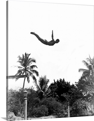1940's Man Poised Midair Jumping From Diving Board Into Pool