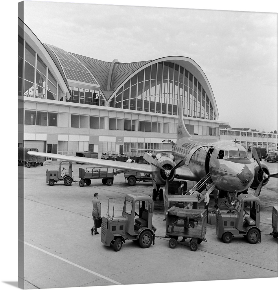 1950s 1960s Propeller Airplane On Airport Tarmac In Front Of Terminal With Modern Arched Windows St. Louis Missouri USA.