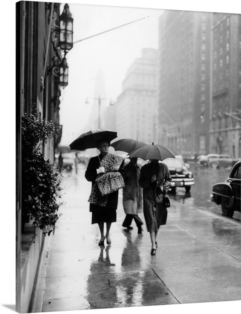 1950's Fashionable Woman Wearing Leopard Skin Muff And Stole Walking Down Rainy City Street.