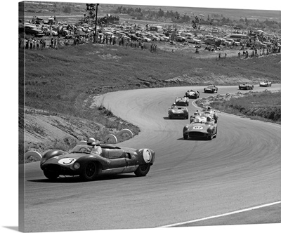 1960's Auto Race On Serpentine Section Of Track With Spectators Watching From Small Hill