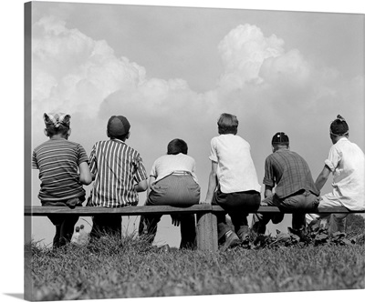 1960s Back View Of Six Anonymous Boy Baseball Players Sitting On Bench
