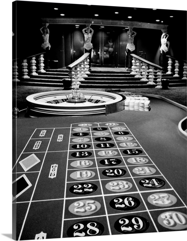 1960s Casino Viewed From End Of Roulette Table Opposite Of Wheel Looking Toward Statues Of Female Showgirls.