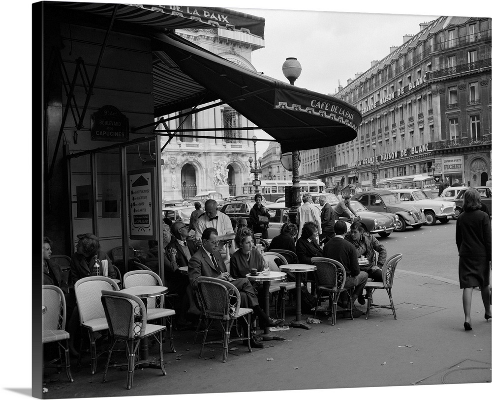 1960's Patrons At Cafe De La Paix Sidewalk Cafe Corner Of Paris Opera House In Background Paris France.