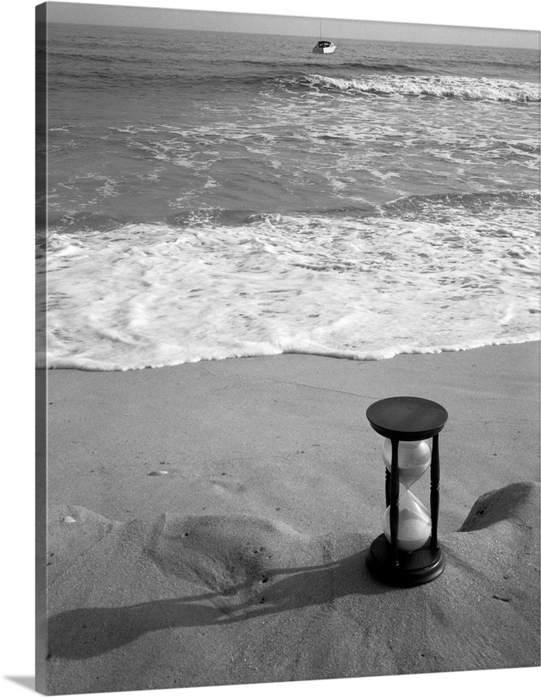 1960's Still Life Of Hourglass At Edge Of Beach Sand With Waves Washing Up On Shore And Power Boat Passing Offshore Tempus...