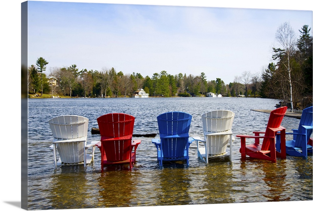 Adirondack chairs partially submerged in the Lake Muskoka, Ontario, Canada