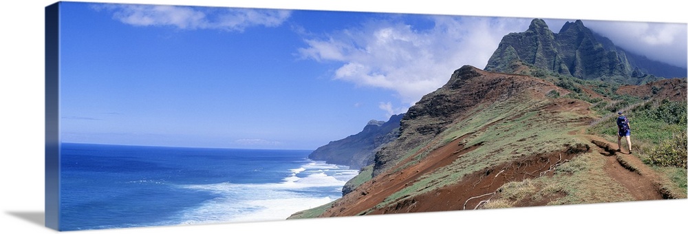 Adult hiking up a mountain, Kalalau Trail , Na Pali Coast, Kauai, Hawaiis