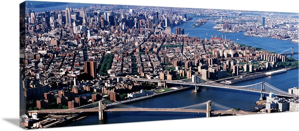 Aerial panorama of suspension bridges and bustling New York City metropolis.