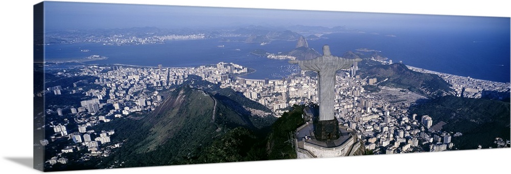 Giant, landscape photograph of the back of Christ the Redeemer statue overlooking Rio de Janeiro, Brazil.