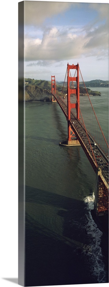 This tall vertical panoramic picture is taken from above the Golden Gate Bridge looking down the road as it crosses onto l...