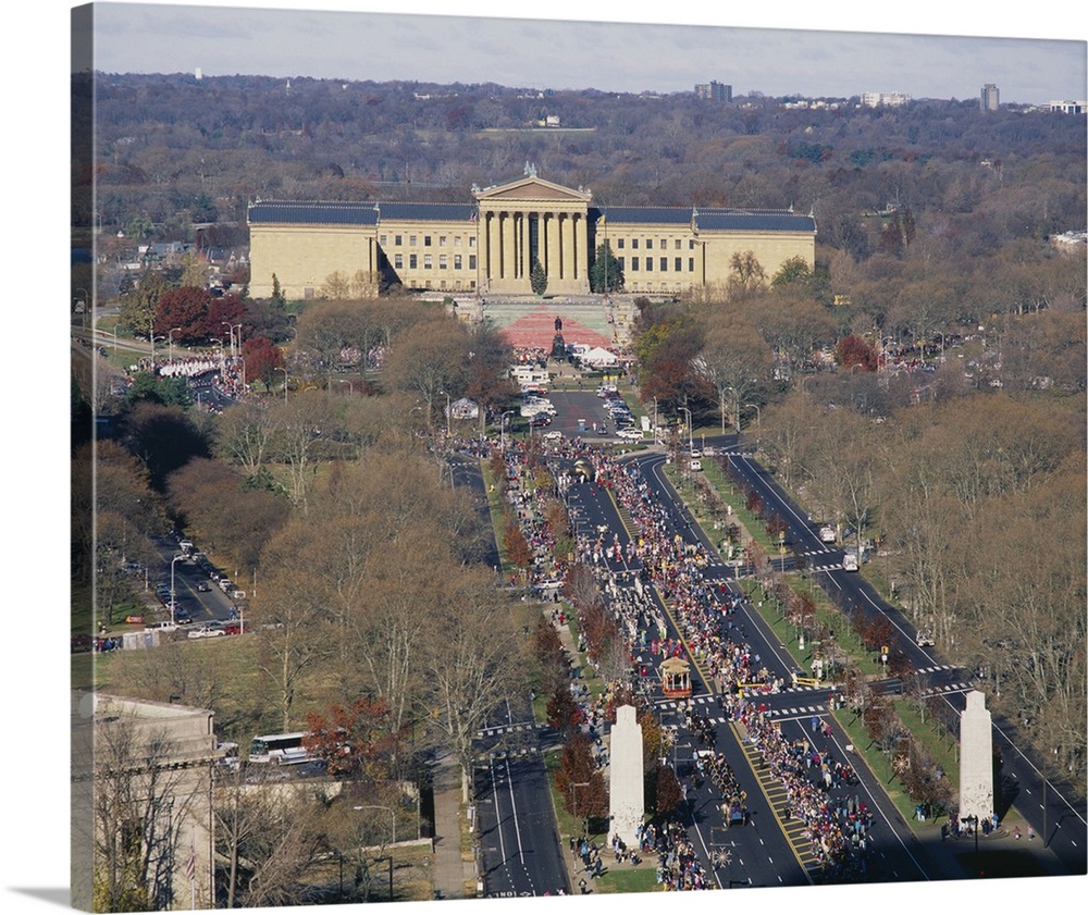The art museum in Philadelphia is photographed from a high angle view as crowds of people walk toward the entrance.