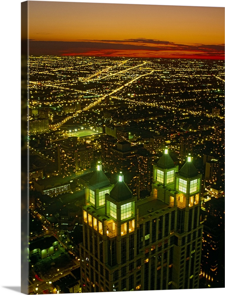 Canvas photo art of a cityscape seen from above lit up at sunset.