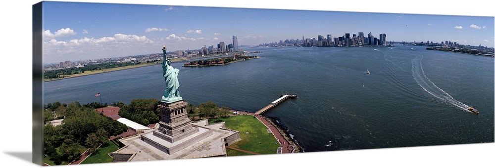 Panoramic photograph of iconic "Big Apple" monument and waterfront under a cloudy sky.