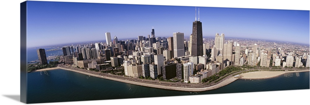 This wide angle photograph was taken from above the Chicago skyline over Lake Michigan that lines the coast of the city.