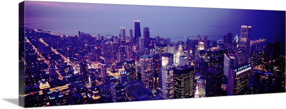 Aerial view of buildings in a city lit up at dusk, Chicago, Illinois