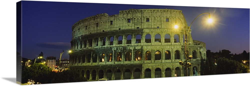 A panorama of the Roman Colosseum at night, with emphasis on the facade.
